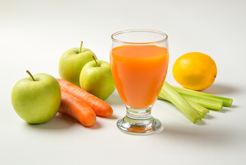 Apple carrot and celery juice on a white background with ingredients. Selected focus.