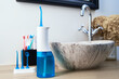 Blue home oral irrigator kit in bathroom, Waterpik for teeth cleaning, portable water flosser for dental care