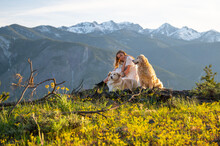 Female In Dress Posing With Dogs With Mountain Views