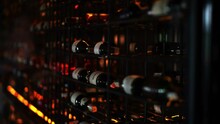 Bottles Of Wine Stands In A Dark Cellar. Wine Factory. Exhibition Stand, Rack Bottles With Alcohol. Soft Focused Footage.
