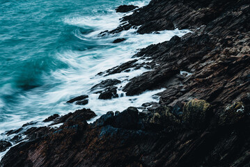 Wall Mural - A beautiful shot of waves breaking on the rocky coast