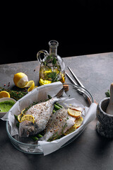 Wall Mural - raw baked dorado fish with asparagus and lemon in spices