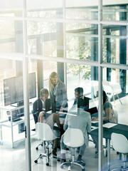 Poster - Presenting ideas to the team. Shot of corporate businesspeople meeting in the boardroom.