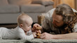 Caucasian family bearded father daddy dad with little daughter son baby infant newborn toddler playing at home on floor with toys collecting wooden constructor spend time together parenting concept