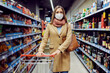© Dusan Petkovic - A young woman doing weekly grocery shopping during a pandemic.
