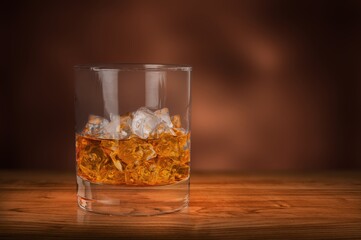 Poster - Glasses of alcohol stand on desk of cognac in wine cellar illuminated by soft light