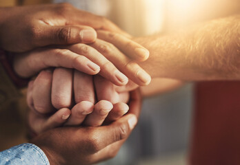 Poster - Many hands, one mind. Shot of a group of people putting their hands together.