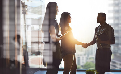 Poster - Lets move business forward together. Cropped shot of businesspeople shaking hands in an office.