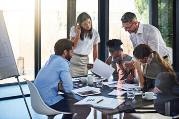 Poster - Strategy session time for the team. Shot of a group of businesspeople having a meeting in a boardroom.