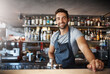 © Jadon Bester/peopleimages.com - Drinks on me. Portrait of a confident young man working behind a bar counter.