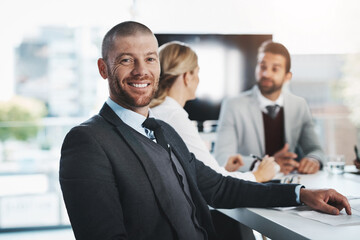 were here to get the job done. portrait of a mature businessman sitting in an office with his collea