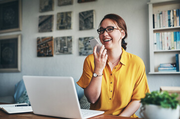 Aufkleber - Keeping in touch with clients has never been easier. Cropped shot of an attractive young businesswoman sitting alone in her home office and talking on her cellphone.