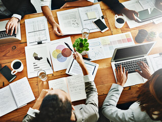 Poster - Reading into what happening in their business. High angle shot of a group of businesspeople having a meeting in an office.
