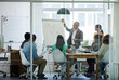 © Yuri Arcurs/peopleimages.com - Putting company policies into perspective. Shot of a group of coworkers in a boardroom meeting.