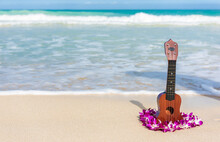 Ukulele And Lei Flower Necklace On Hawaii Beach. Hawaiian Travel Icons For Tourism Vacation Background.