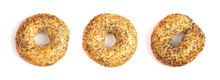 A Row Of Three Evertything Bagels Isolated On A White Background