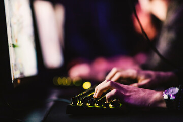 Wall Mural - Close up of gamer using keyboard at gaming room.