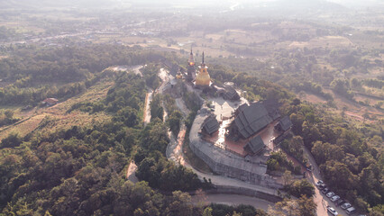 Wall Mural - Wat Somdet Phu Ruea Ming Mueang Temple 4k fly over aerial view. Temple is built with fine wood timber. The church is made of teak and locate on mountain and best viewpoint at Phu ruea, Loei, Thailand