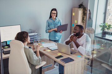 Wall Mural - Photo of thoughtful happy managers sitting table having coffee break discuss last news indoors workplace workstation