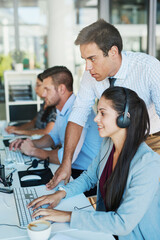 Aufkleber - He maintains a visible presence in his department. Shot of a young man assisting his colleague in a call center.