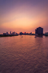 Wall Mural - Shipping boat to harbor on Saigon river, aerial view. Center Ho Chi Minh City, Vietnam with development buildings, transportation, energy power infrastructure.