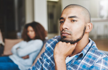Poster - Dont talk to me. Shot of a young man looking upset after a fight with his wife in the background.