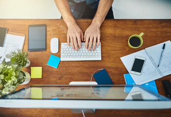 Poster - Another day in the office. High angle shot of an unrecognizable businessman working on his computer in the office.