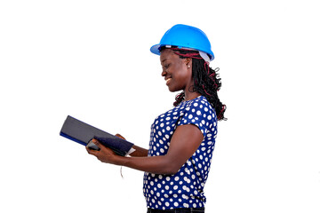 Wall Mural - young female engineer reading the notes in the notebook smiling.