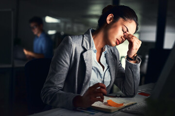 Fototapete - Burn out, not good for you nor the business. Cropped shot of a young attractive businesswoman working late at night in the office.