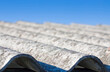 Old aged dangerous roof made of corrugated asbestos panels - one of the most dangerous materials in buildings and construction industry so-called hidden killer