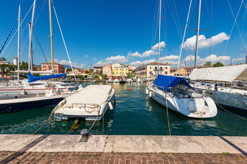 Wall Mural - Small port of Bardolino village with small boats and yachts moored. Tourist resort on the coast of Lake Garda (Lago di Garda). Verona province, Veneto, Italy, southern Europe. 