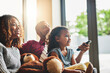 © Delmaine Donson/peopleimages.com - Weekends are about doing what everybody loves. Shot of a happy young family of three watching tv from the sofa at home.