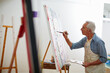 © Daniel Laflor/peopleimages.com - Makers gonna make. Shot of a senior man working on a painting at home.