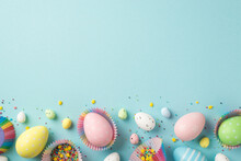 Top View Photo Of Easter Decorations Multicolored Easter Eggs In Paper Baking Molds And Confectionery Topping On Isolated Pastel Blue Background With Copyspace