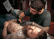 © Mr. Prof - Tattooer making tattoo art in tattoo parlor