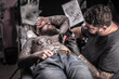 © Mr. Prof - Master working on professional tattoo machine device in tattoo studio