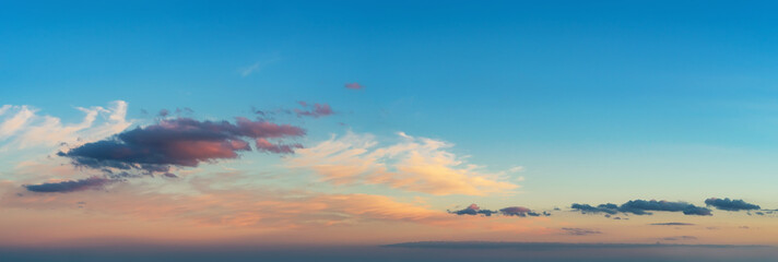 Wall Mural - pastel colored scenic skyscape at sunset. vanilla sky. light pink and dark blue clouds low on the ho