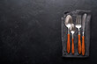 Vintage silverware. Rustic vintage set of wooden spoon and fork on black background. Top view. Mock up.