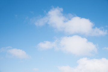 Wall Mural - gradient blue sky background with soft cumulus clouds