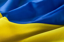 Fabric Textured Flag Of Ukraine, UA. Blue And Yellow Colors. Close Up Shot, Selective Focus, Background