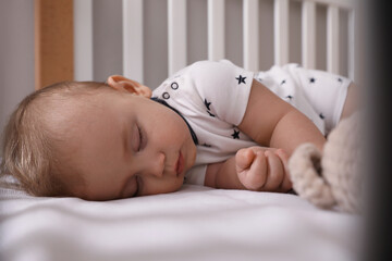 Sticker - Adorable little baby sleeping in crib, closeup