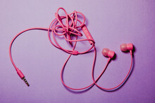 Colored Tangled Headphones On A Lilac Background