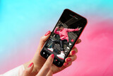 Fototapeta  - Sample social media app interface on mobile phone showing shared video content