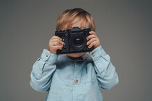 Little Kid Photographer With Photocamera Isolated On Gray