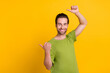 © deagreez - Profile side photo of young guy indicate thumbs empty space promotion discount isolated over yellow color background