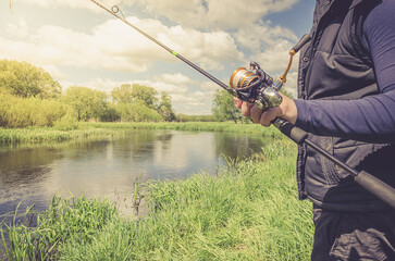 Wall Mural - Fisherman with a fishing rod.