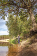 © alexey351 - Fisherman on the bank of a beautiful river.