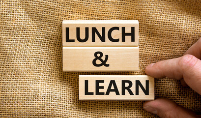 Poster - Lunch and learn symbol. Concept words Lunch and learn on wooden blocks. Beautiful canvas table canvas background. Businessman hand. Copy space. Business, educational and lunch and learn concept.