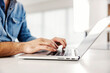 © dusanpetkovic1 - Side view of male hands typing on the laptop.