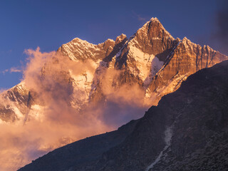 Wall Mural - golden clouds between mountains walls in nepal